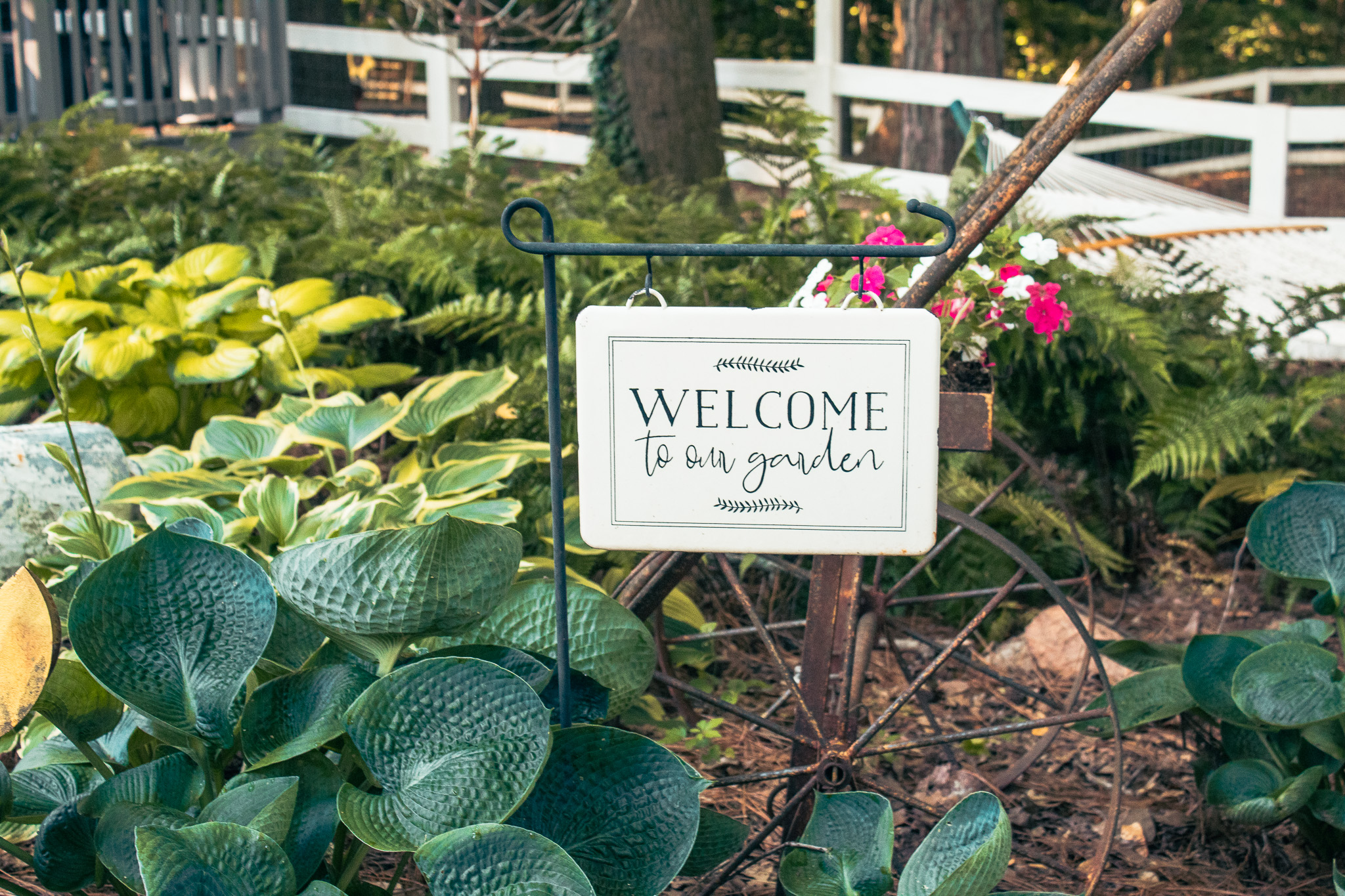 Welcome to our garden sign by a vintage cart
