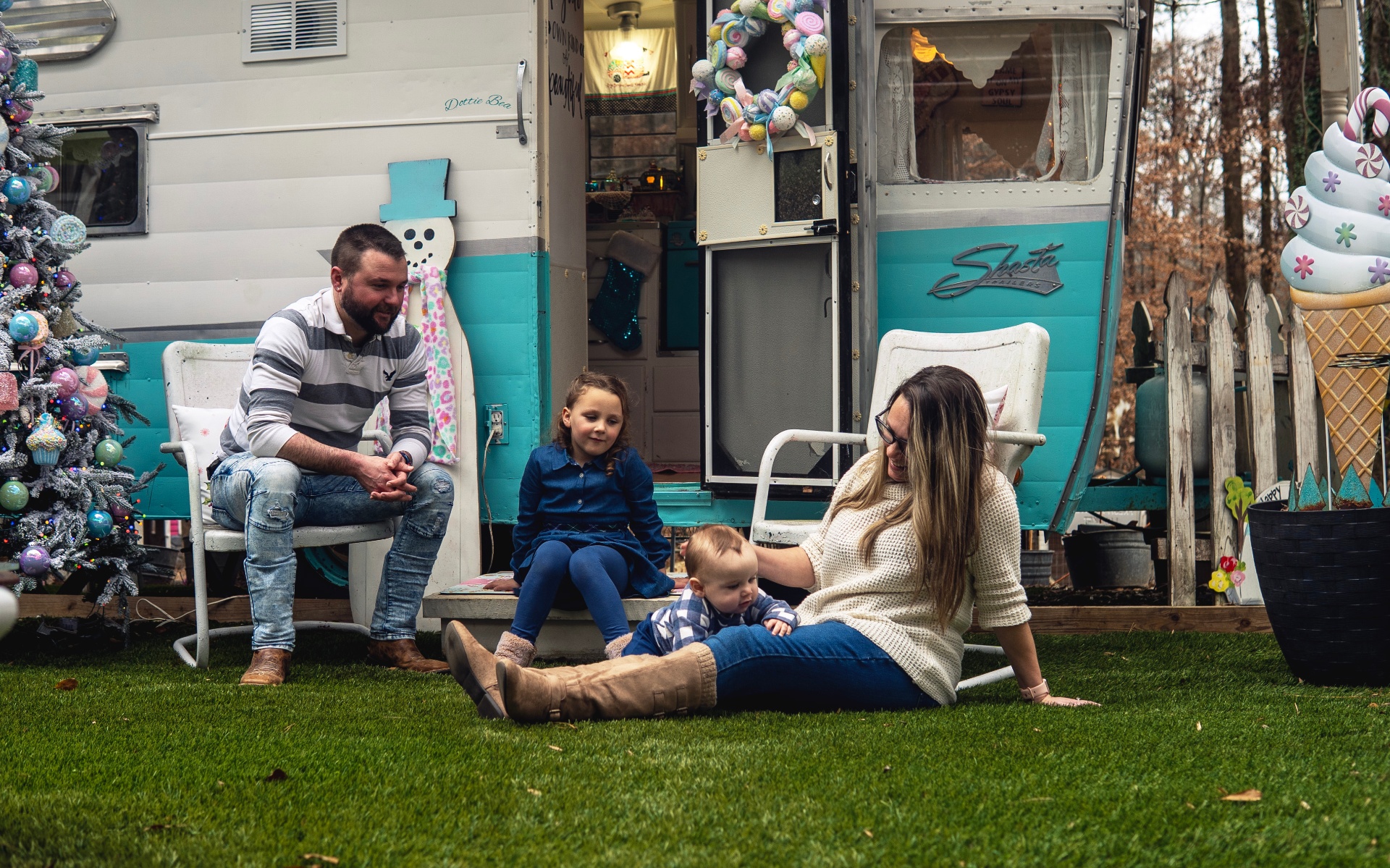 Family relaxing by the vintage camper