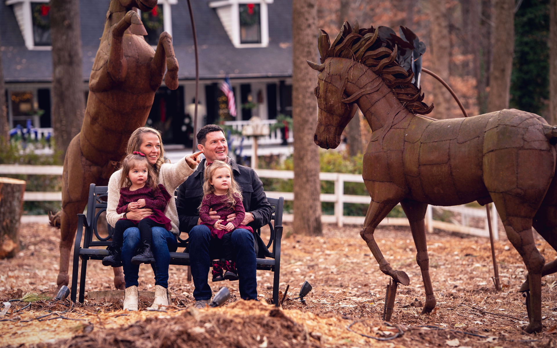 Family with metal horse sculptures