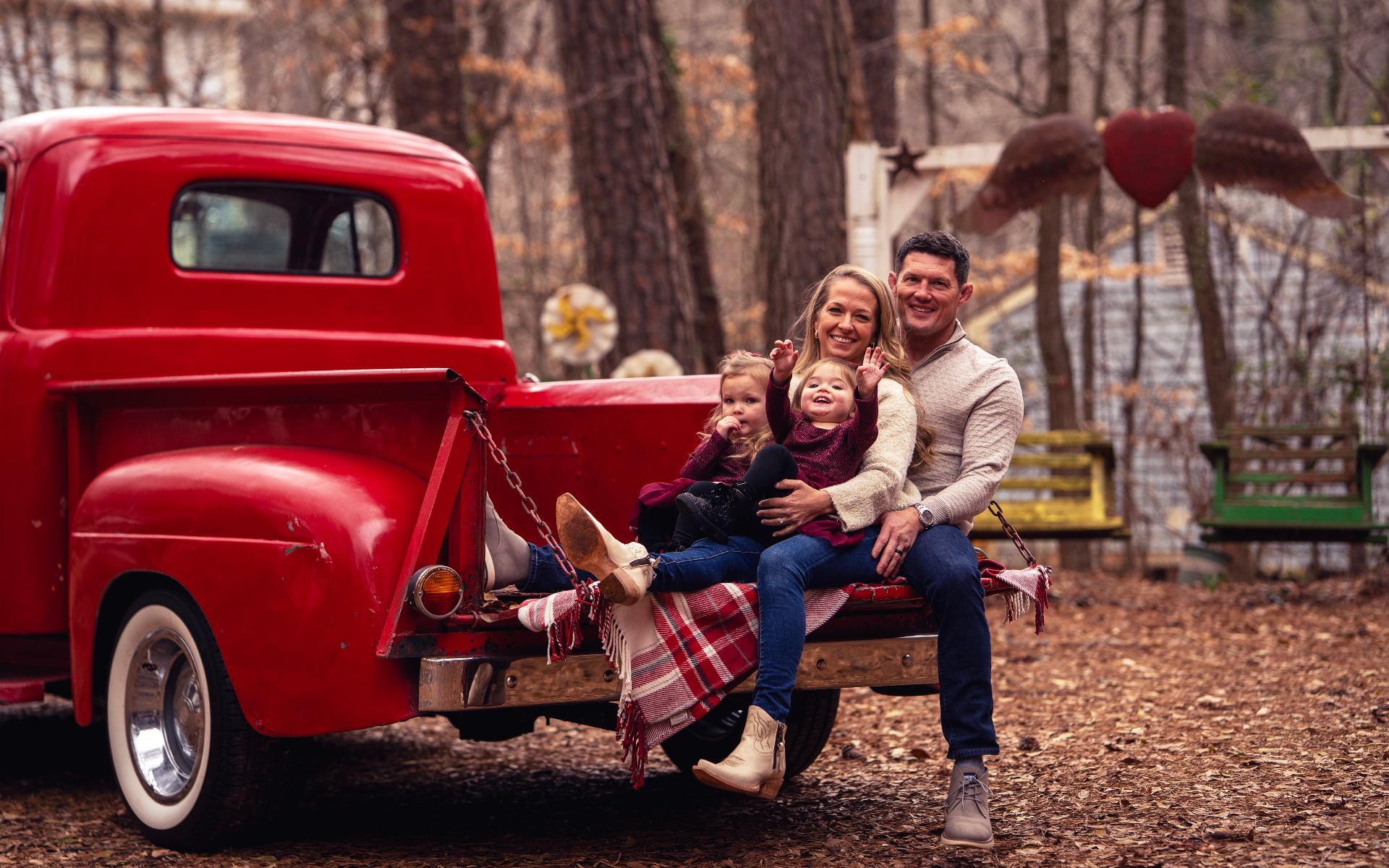 Family on the red truck tailgate