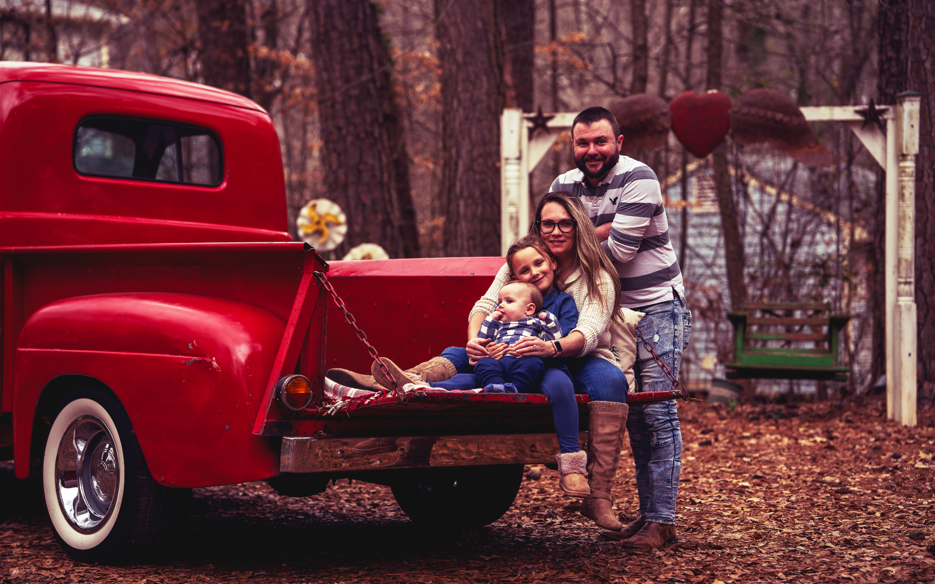 Family cuddling on the truck tailgate